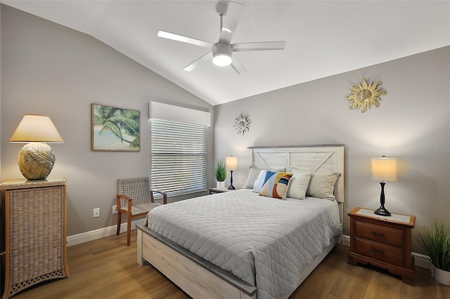 bedroom with ceiling fan, vaulted ceiling, baseboards, and wood finished floors