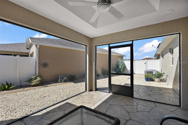 sunroom / solarium featuring ceiling fan and a tray ceiling