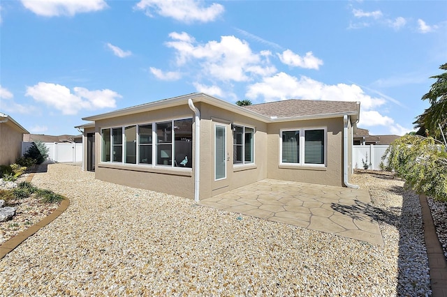 back of property with a patio, a fenced backyard, and stucco siding