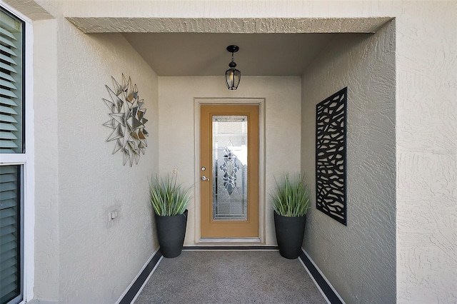 doorway to property with stucco siding