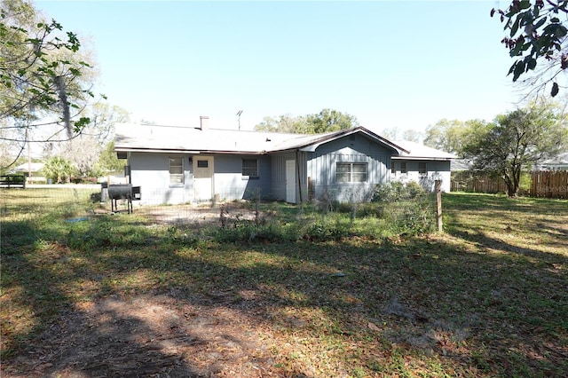 rear view of property featuring fence