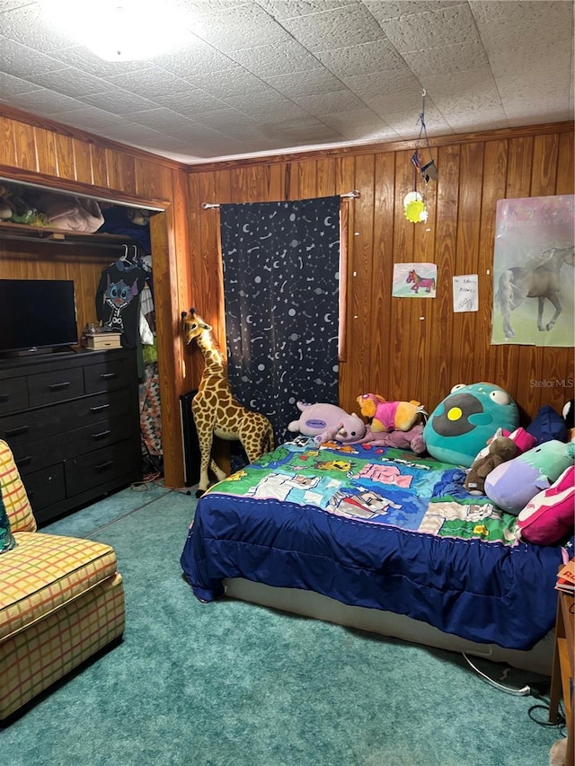 carpeted bedroom with wood walls