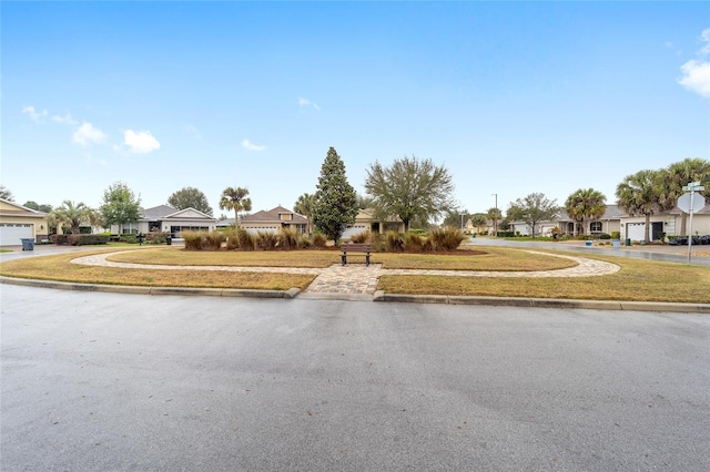 view of street with a residential view, curbs, and sidewalks