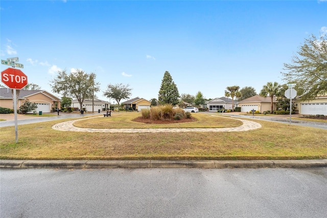 view of yard featuring a residential view and driveway