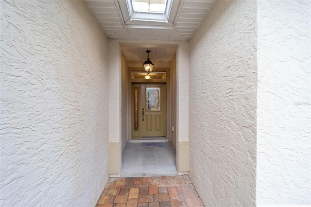 view of exterior entry featuring stucco siding