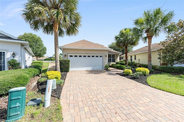 8669 SW 88th Loop, Ocala, FL 34481 - single story home featuring an attached garage, decorative driveway, and stucco siding