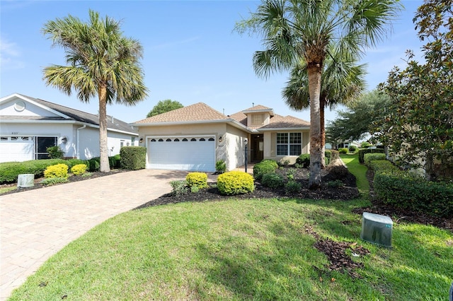 8669 SW 88th Loop, Ocala, FL 34481 - single story home with an attached garage, driveway, stucco siding, and a front lawn