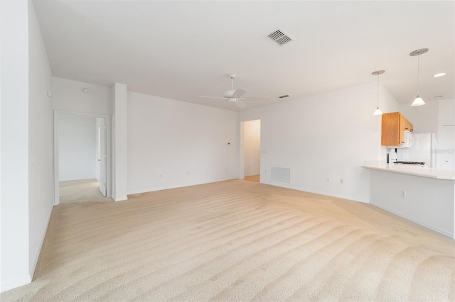 8669 SW 88th Loop, Ocala, FL 34481 - unfurnished living room featuring light carpet, ceiling fan, and baseboards