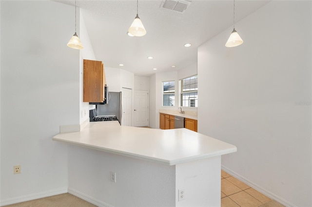8669 SW 88th Loop, Ocala, FL 34481 - kitchen featuring stainless steel appliances, brown cabinets, light countertops, a peninsula, and recessed lighting