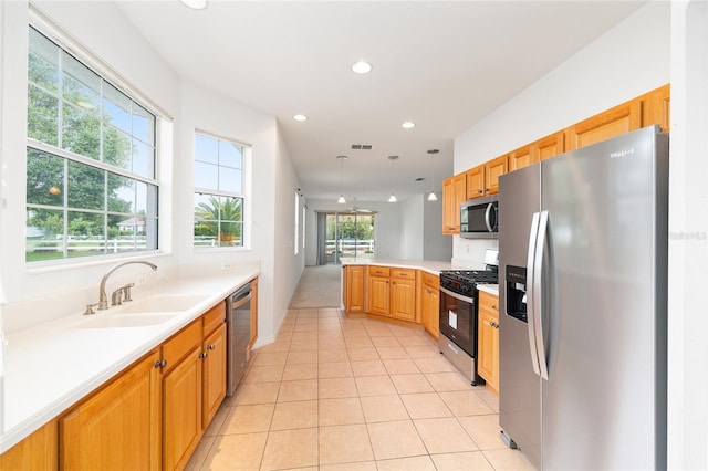 8669 SW 88th Loop, Ocala, FL 34481 - kitchen featuring stainless steel appliances, a sink, a peninsula, light countertops, and recessed lighting