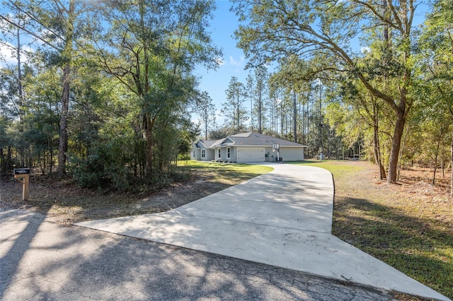 view of front facade with an attached garage, driveway, and a front yard