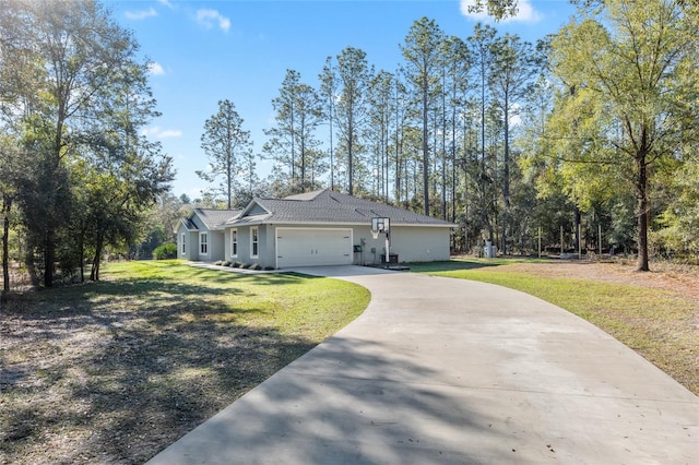 view of front facade with a garage, concrete driveway, a front lawn, and stucco siding