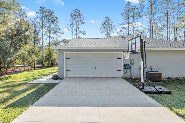 garage featuring concrete driveway and central air condition unit