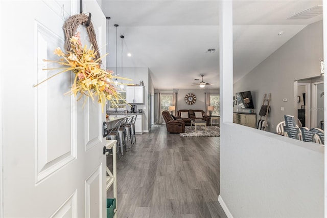 foyer entrance featuring high vaulted ceiling, a ceiling fan, visible vents, and wood finished floors