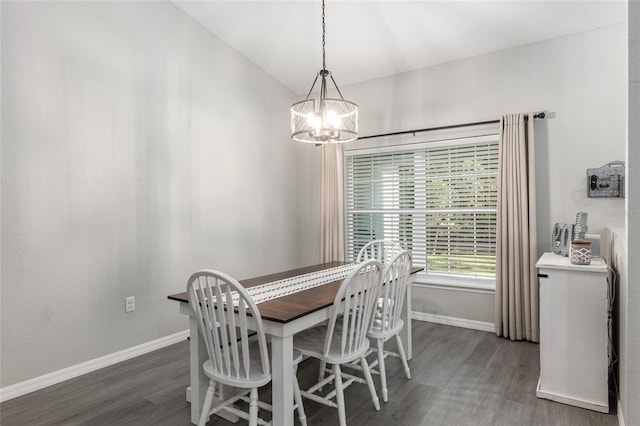 dining room with a chandelier, vaulted ceiling, wood finished floors, and baseboards