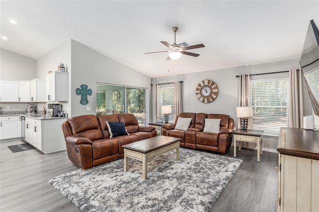 living room with light wood-style floors, ceiling fan, vaulted ceiling, and recessed lighting