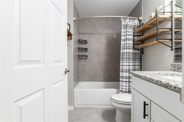 bathroom featuring a textured ceiling, toilet, vanity, tile patterned floors, and shower / bath combo with shower curtain