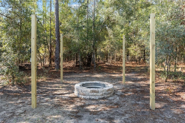 view of yard with a fire pit