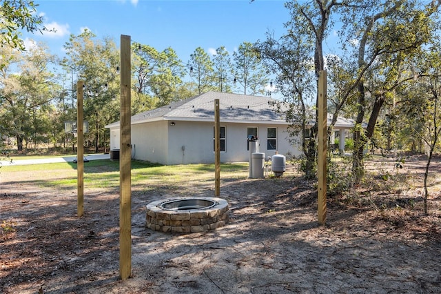 view of yard with a fire pit