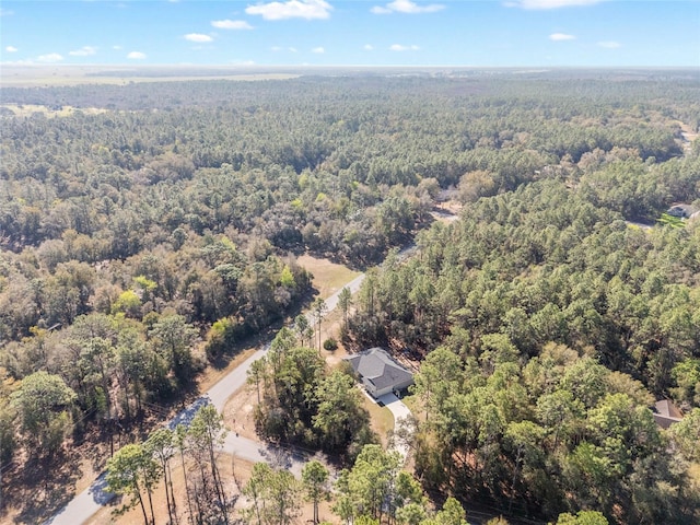 drone / aerial view featuring a view of trees