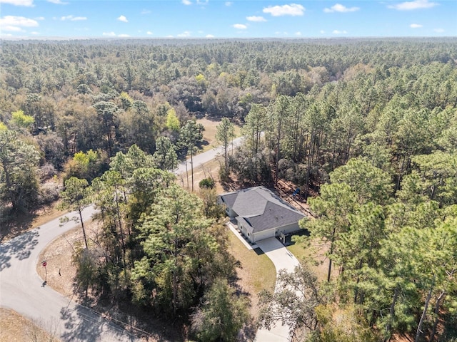 drone / aerial view featuring a forest view