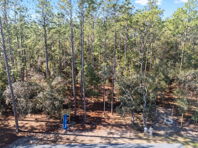 view of yard with a view of trees