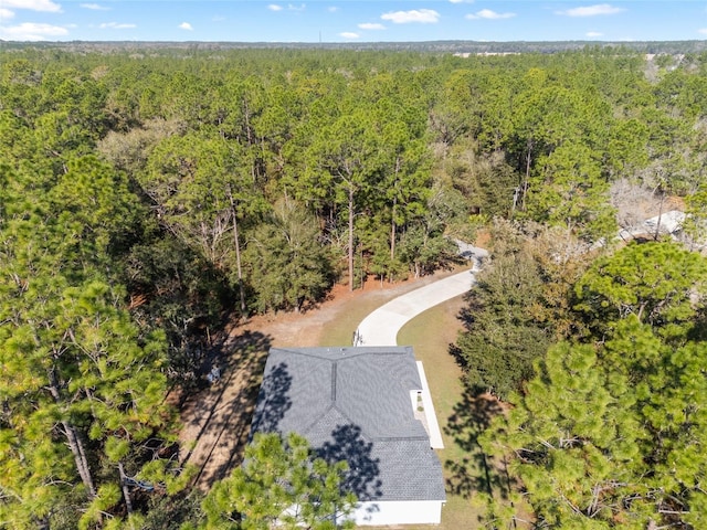 drone / aerial view featuring a forest view