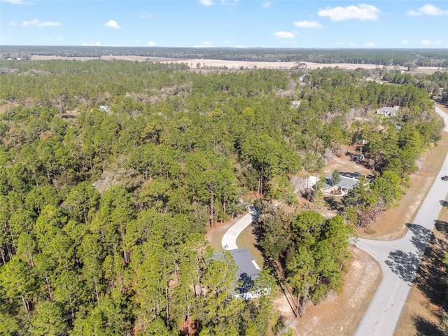 birds eye view of property with a wooded view