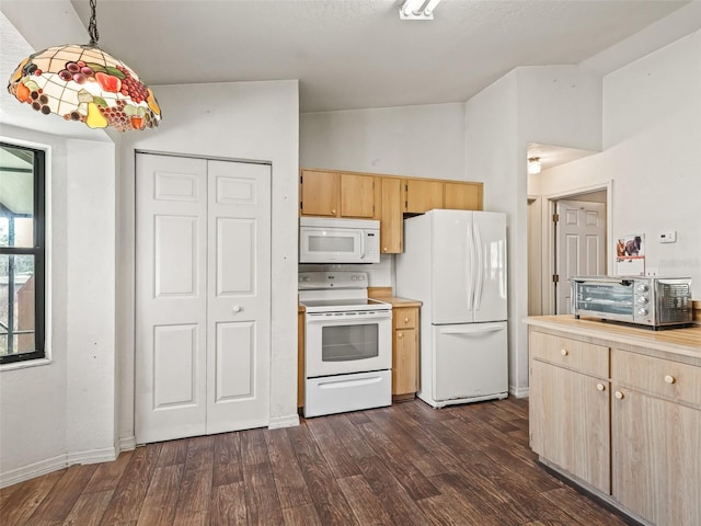 kitchen featuring a toaster, lofted ceiling, light brown cabinetry, dark wood-type flooring, and white appliances