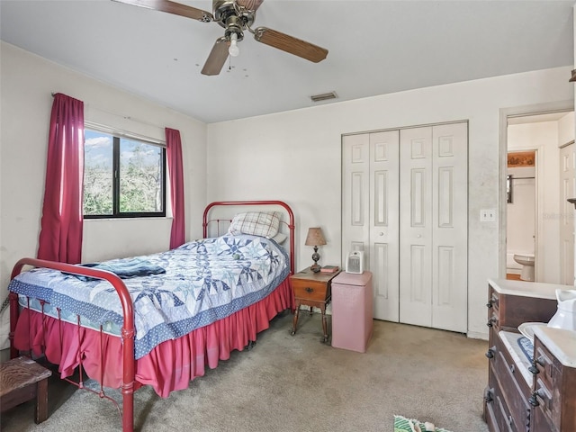 carpeted bedroom with ceiling fan, a closet, and visible vents