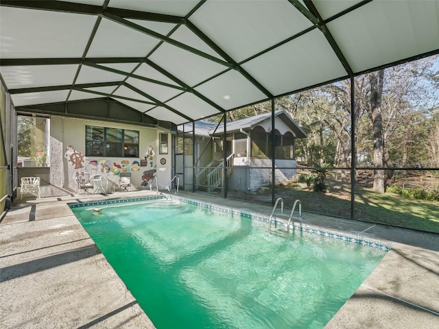 outdoor pool with a lanai, a patio area, and a sunroom