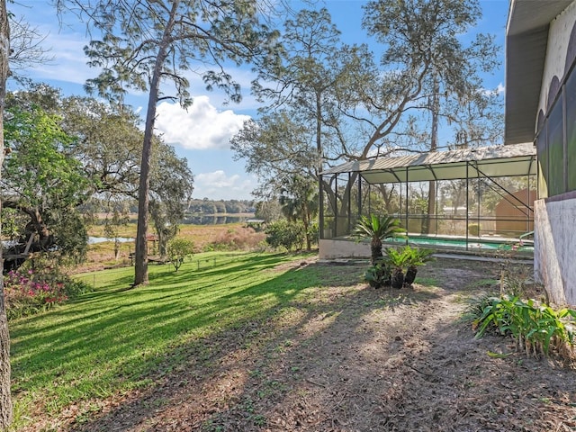 view of yard with glass enclosure and an outdoor pool