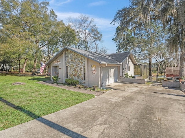 view of side of property featuring stucco siding, a lawn, an attached garage, stone siding, and driveway