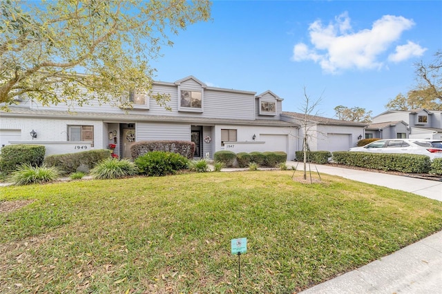 view of front of property with concrete driveway, an attached garage, and a front lawn