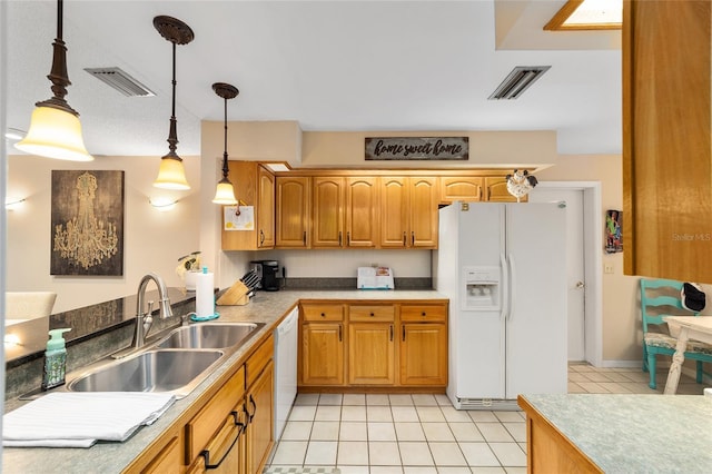 kitchen featuring white appliances, visible vents, a sink, and decorative light fixtures