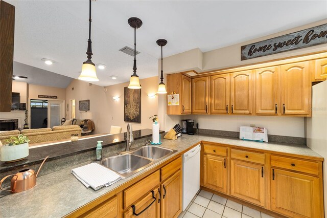 kitchen featuring white appliances, light tile patterned floors, open floor plan, decorative light fixtures, and a sink