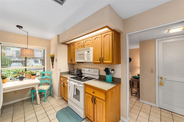 kitchen featuring hanging light fixtures, white appliances, light tile patterned floors, and baseboards