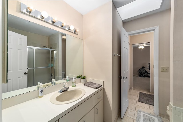 full bath with a stall shower, vanity, toilet, and tile patterned floors