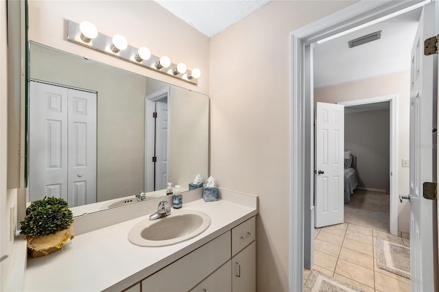 bathroom with vanity, visible vents, and tile patterned floors