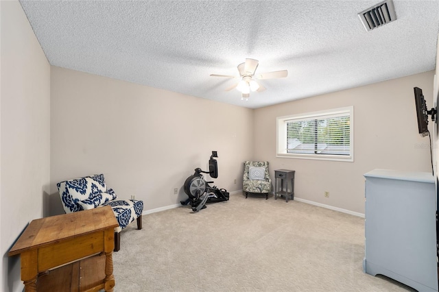 sitting room with ceiling fan, carpet, visible vents, and baseboards