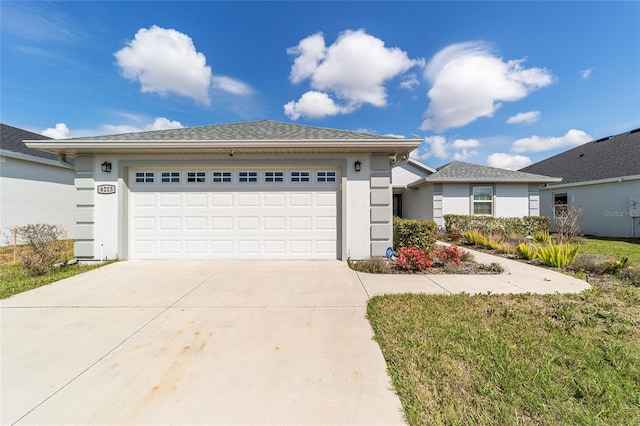 single story home featuring concrete driveway, roof with shingles, an attached garage, and stucco siding