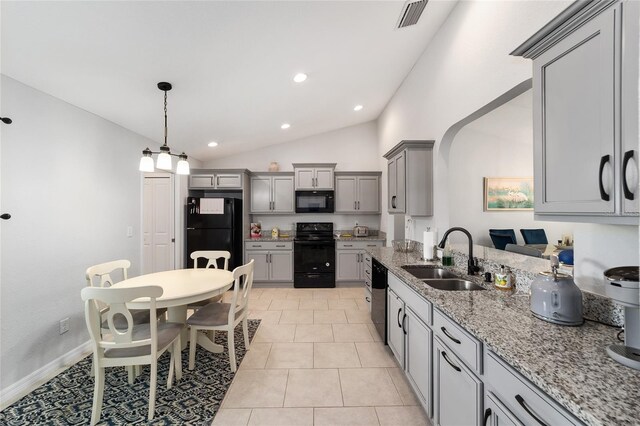 kitchen with arched walkways, visible vents, gray cabinetry, a sink, and black appliances