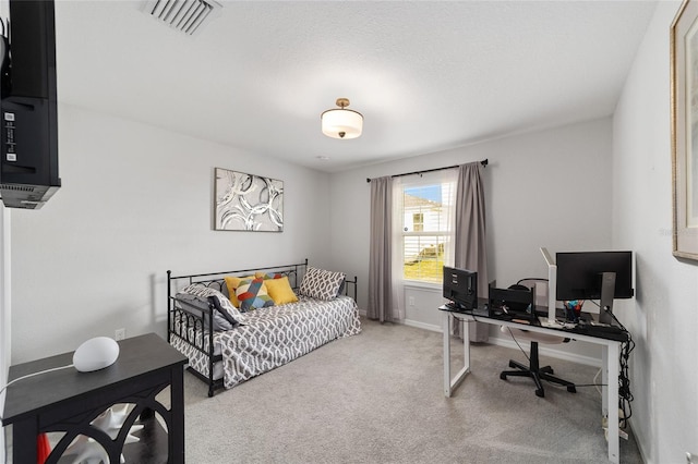 carpeted bedroom with baseboards and visible vents