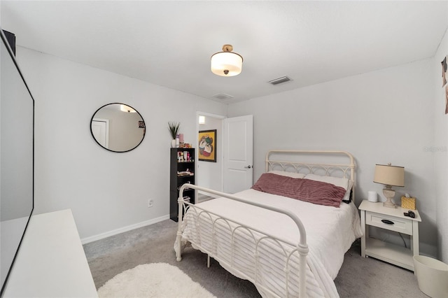 bedroom with carpet floors, visible vents, and baseboards