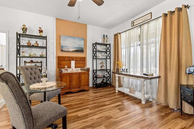 living area with light wood-type flooring and ceiling fan