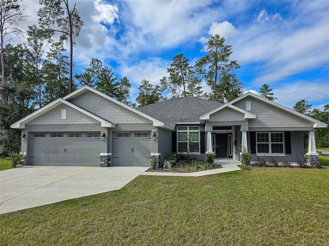 craftsman inspired home featuring a garage, concrete driveway, and a front yard