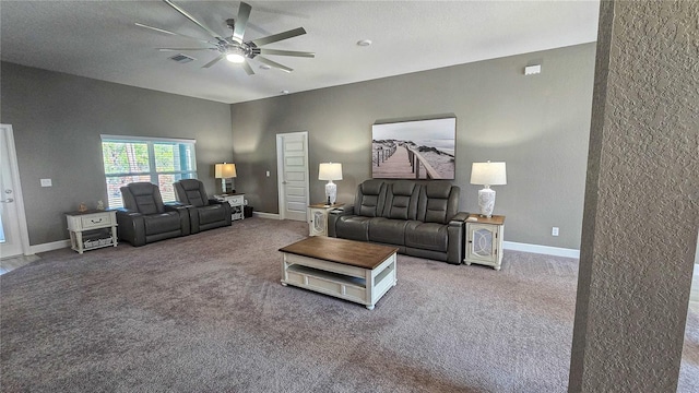 living room with carpet flooring, ceiling fan, visible vents, and baseboards