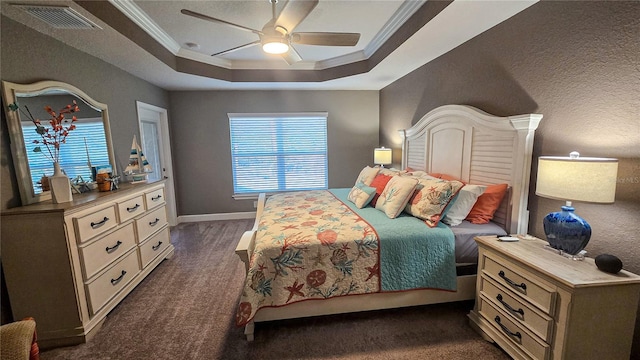 bedroom featuring baseboards, visible vents, a ceiling fan, a tray ceiling, and crown molding