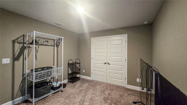 interior space with carpet flooring, visible vents, and baseboards