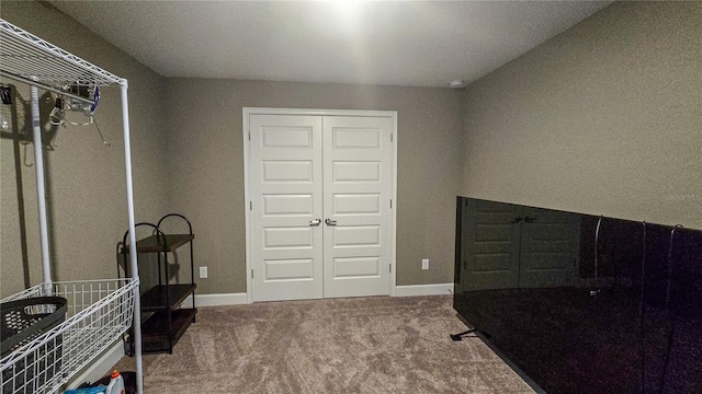 interior space with carpet and baseboards